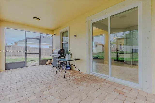 a view of a porch with chairs and backyard
