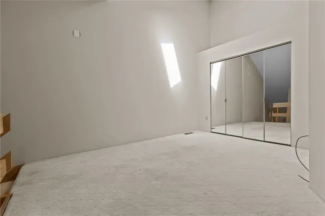 a view of an empty room with glass door