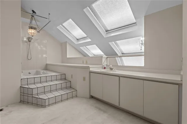 an empty room with windows and cabinet