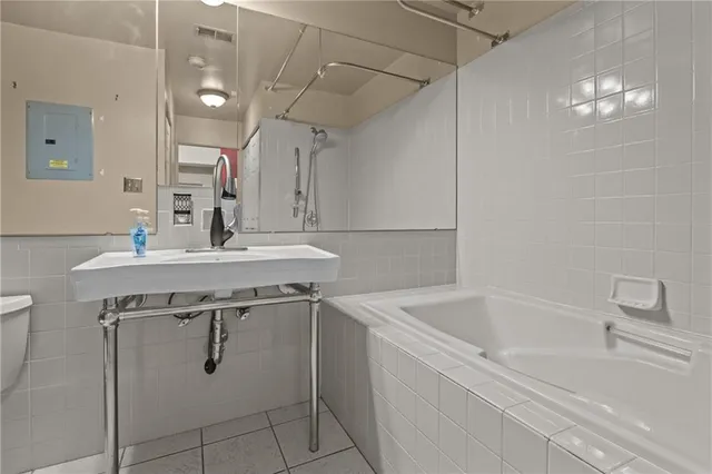 a bathroom with a sink a toilet a mirror and vanity