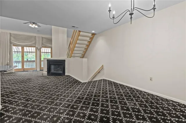 a view of a livingroom with wooden floor and windows