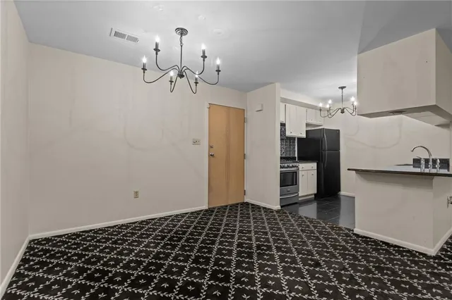 a view of a hallway with a refrigerator