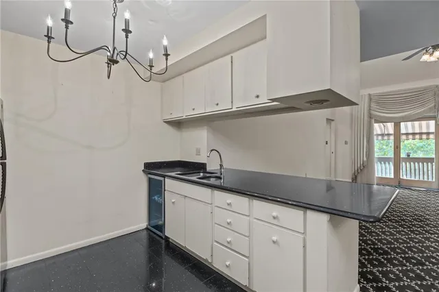 a kitchen with granite countertop white cabinets and white appliances