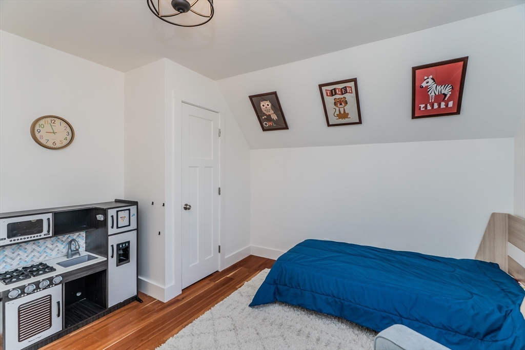 267 Shutesbury Road Amherst, MA 01002 - Photo 36 of 42 a bed room with a bed and a chair