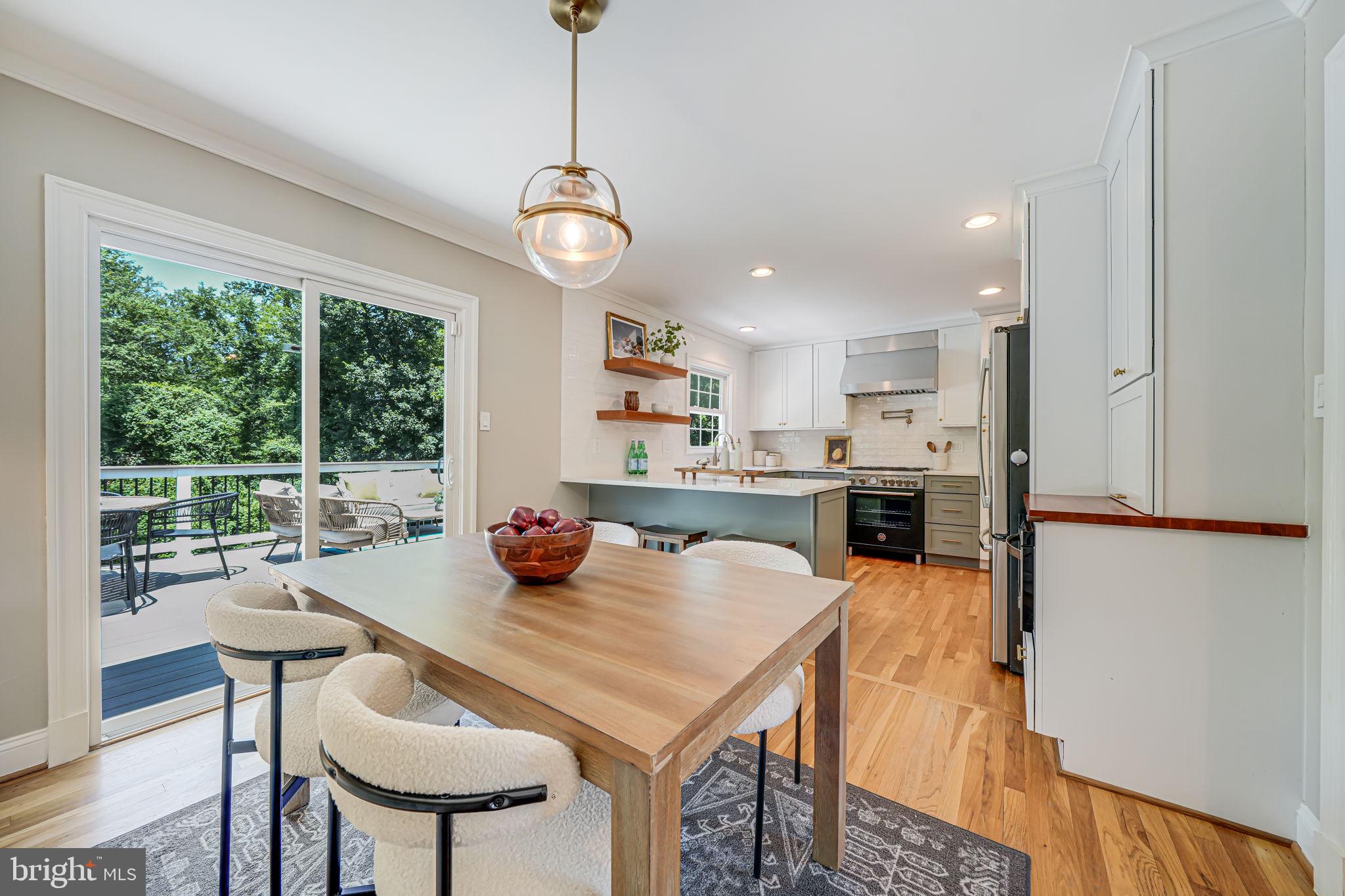 1930 Foxhall Road McLean, VA 22101 - Photo 12 of 62 a view of a dining room with furniture a chandelier and wooden floor