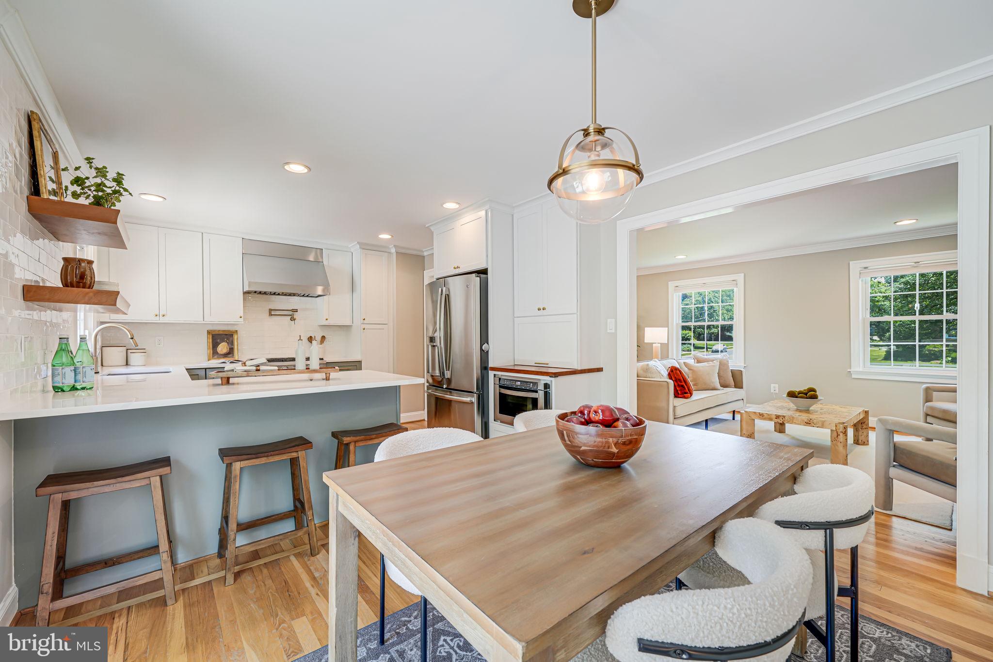 1930 Foxhall Road McLean, VA 22101 - Photo 14 of 62 a view of a dining room and a kitchen with a table chairs a chandelier