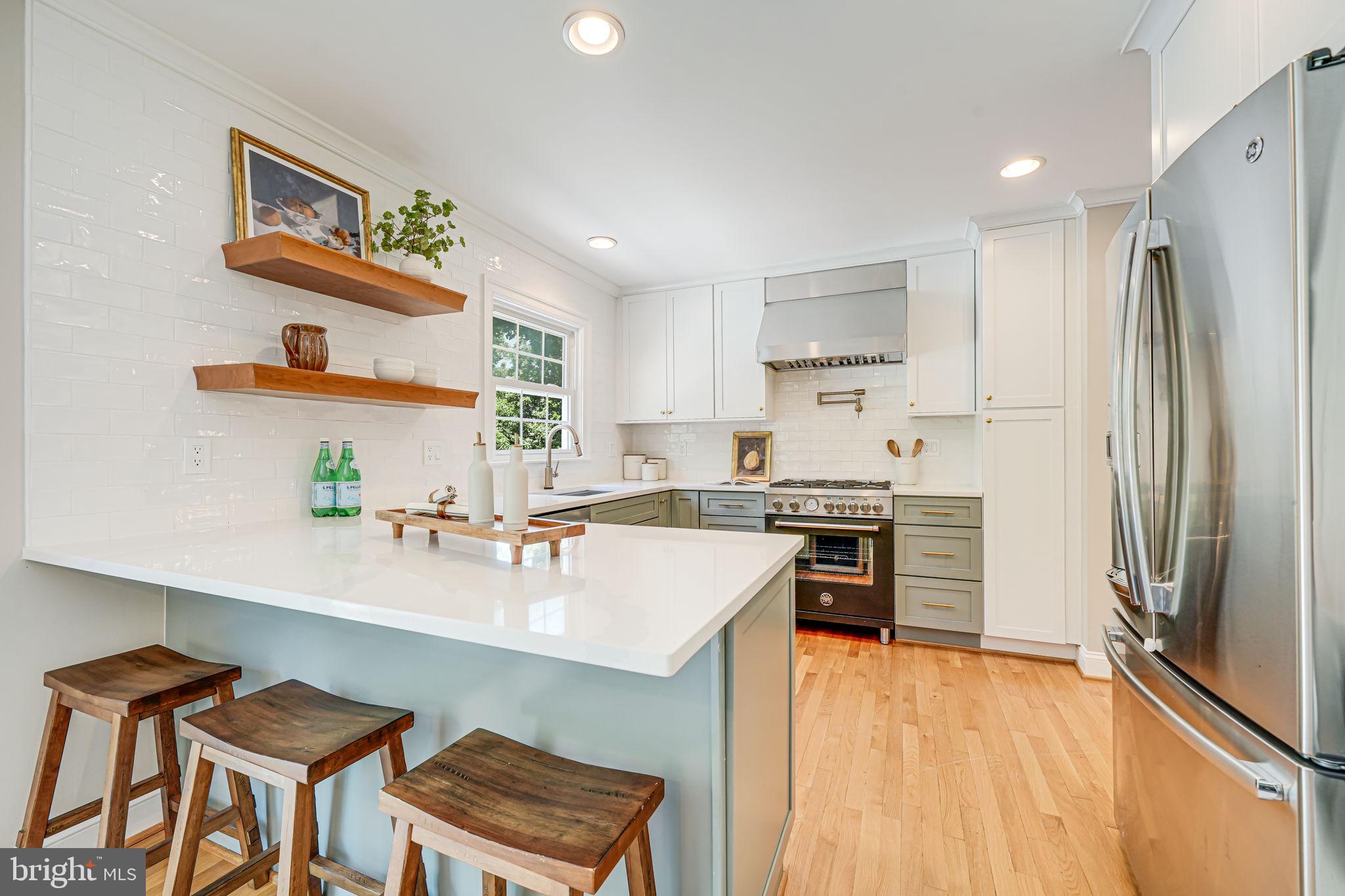 1930 Foxhall Road McLean, VA 22101 - Photo 16 of 62 a kitchen with a refrigerator and a stove top oven