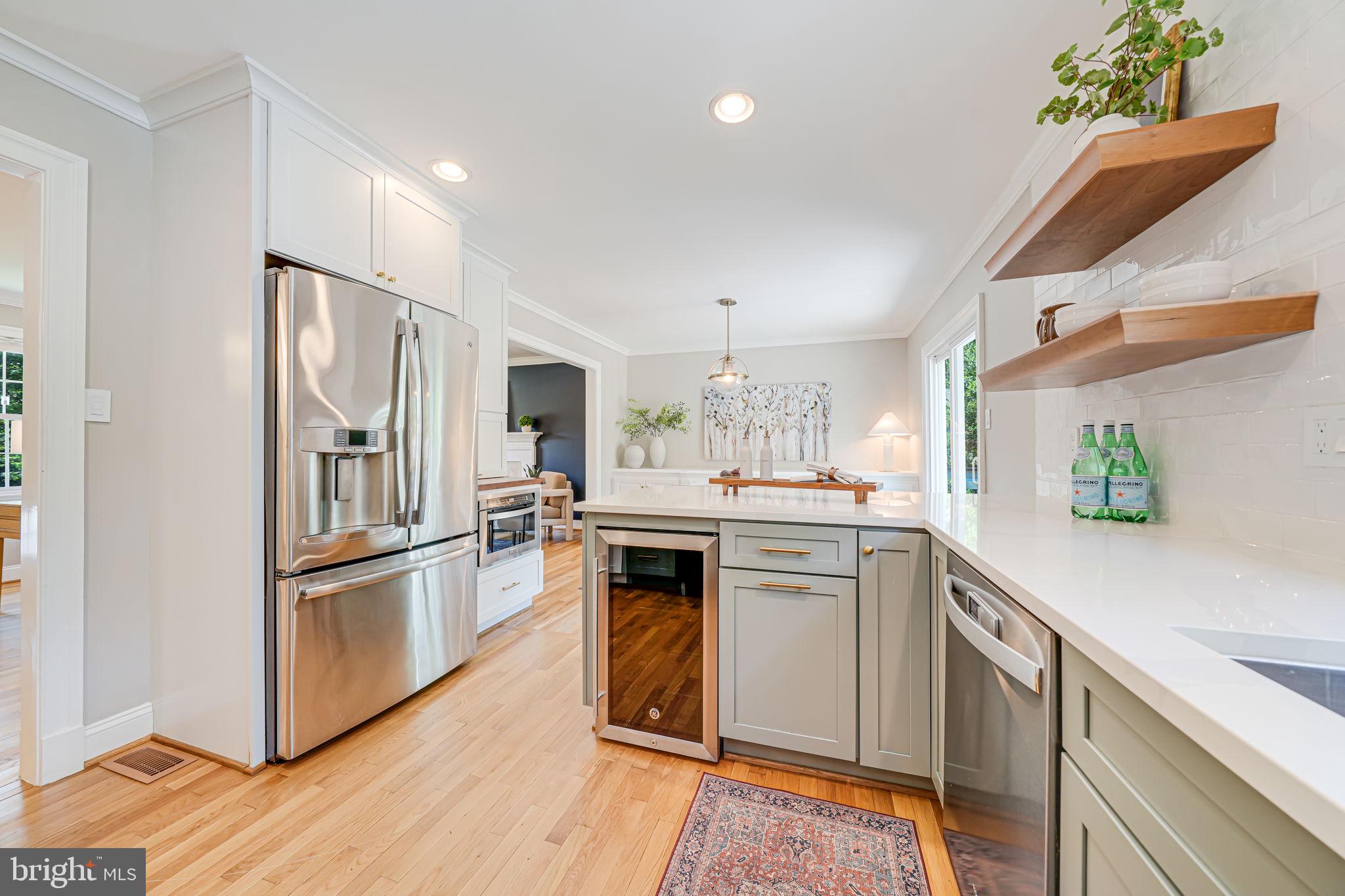 1930 Foxhall Road McLean, VA 22101 - Photo 20 of 62 a kitchen with stainless steel appliances white cabinets and wooden floor