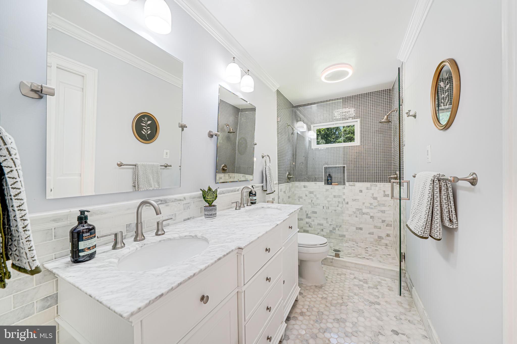 1930 Foxhall Road McLean, VA 22101 - Photo 25 of 62 a bathroom with a granite countertop sink a toilet and a mirror