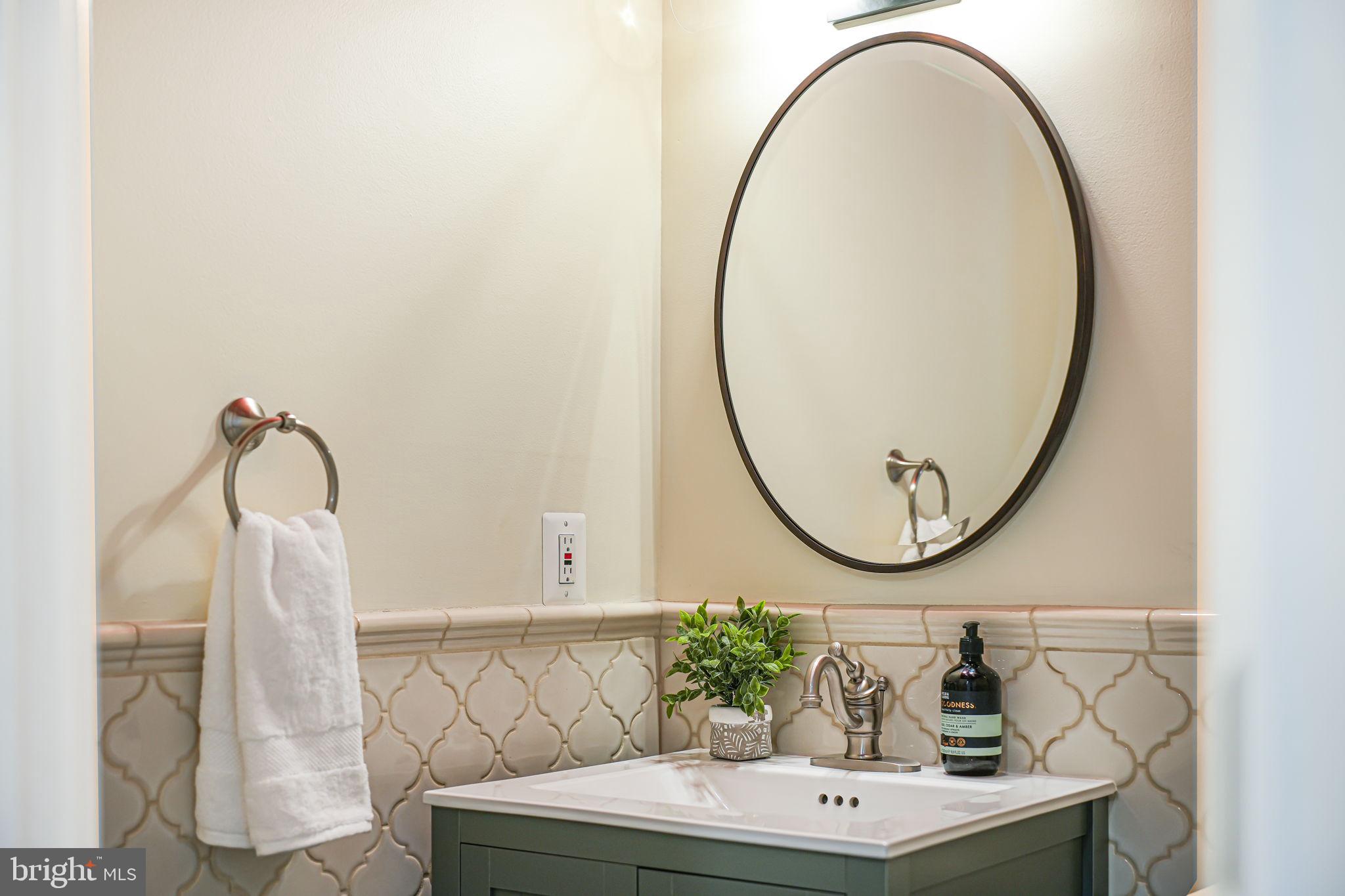 1930 Foxhall Road McLean, VA 22101 - Photo 38 of 62 a bathroom with a sink a mirror and a vanity