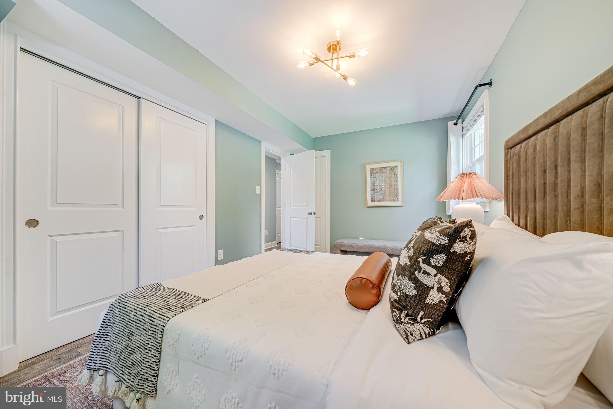 1930 Foxhall Road McLean, VA 22101 - Photo 42 of 62 a bedroom with a bed and a chandelier