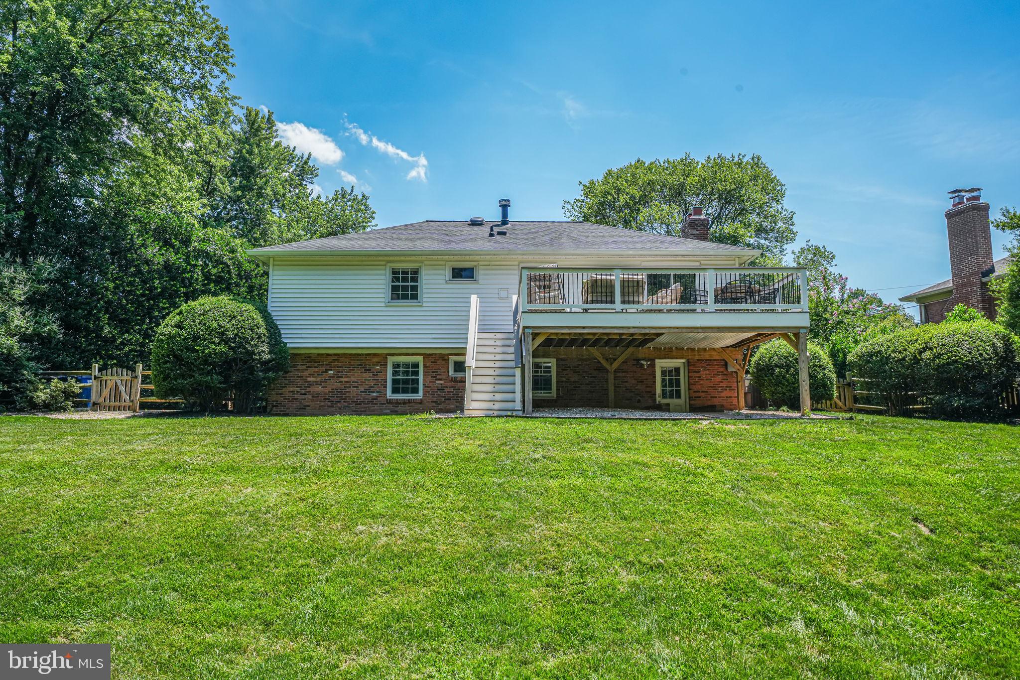 1930 Foxhall Road McLean, VA 22101 - Photo 52 of 62 a front view of house with yard and trees in the background