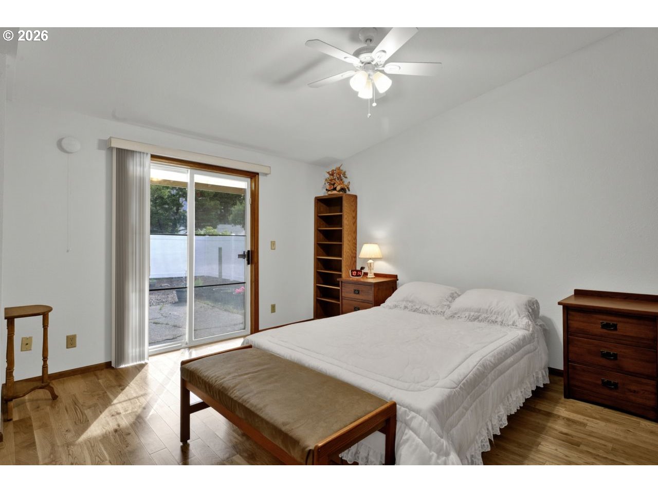 1960 40th Street Florence, OR 97439 - Photo 27 of 48 a bedroom with a bed and a chandelier