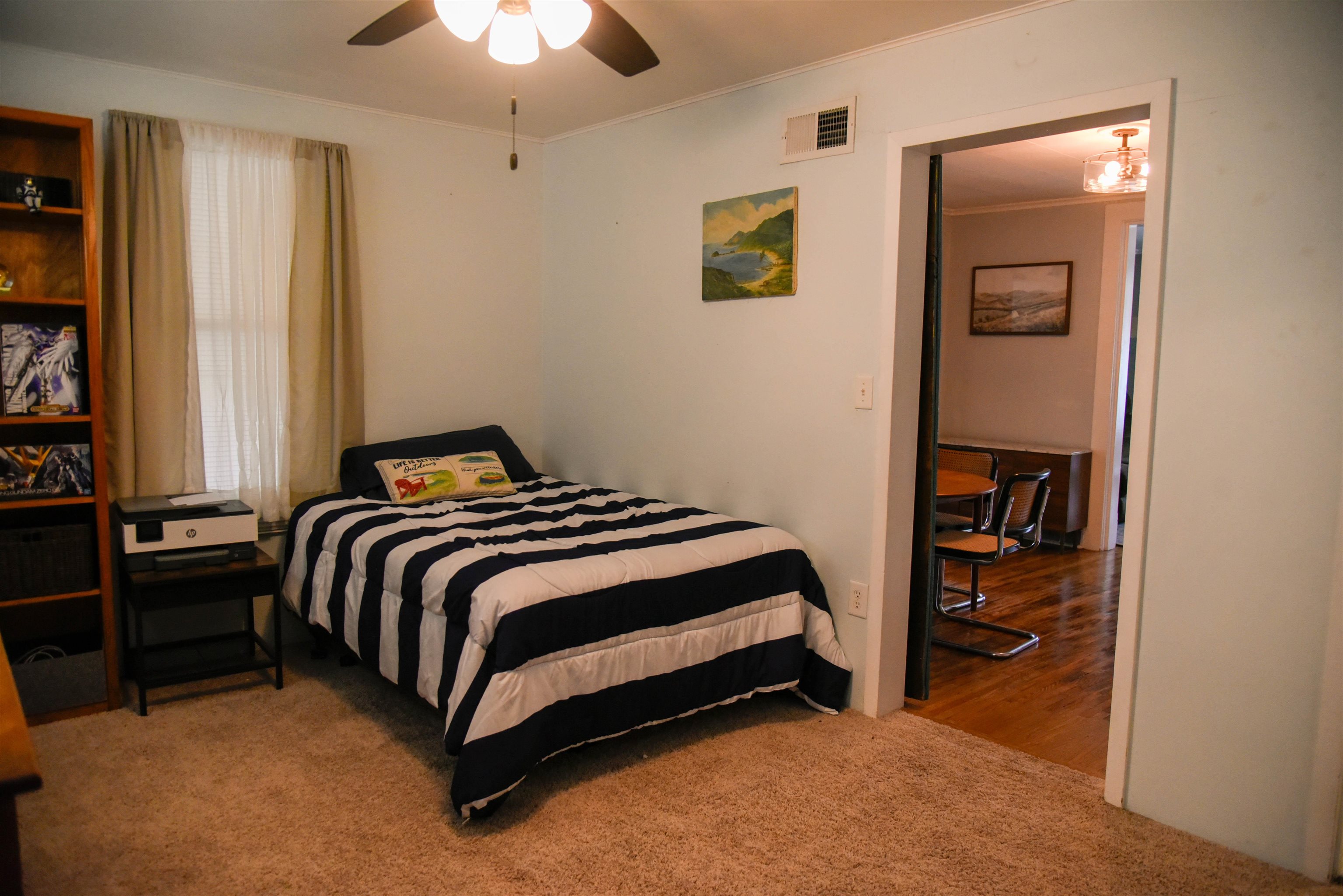 120 North Booth Street Dubuque, IA 52001 - Photo 15 of 26 a bedroom with a bed and a chandelier
