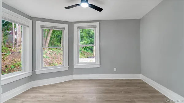 wooden floor in an empty room and a window