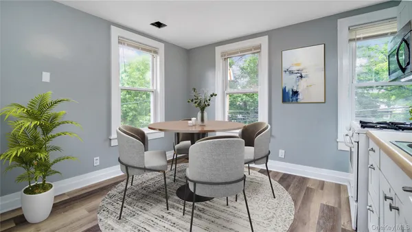 a dining room with furniture and wooden floor