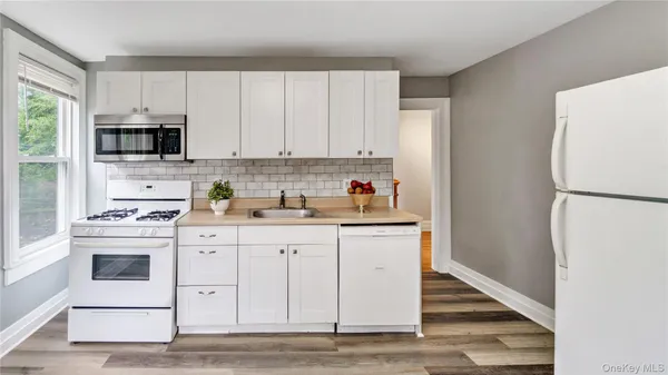 a kitchen with stainless steel appliances granite countertop a refrigerator sink and stove