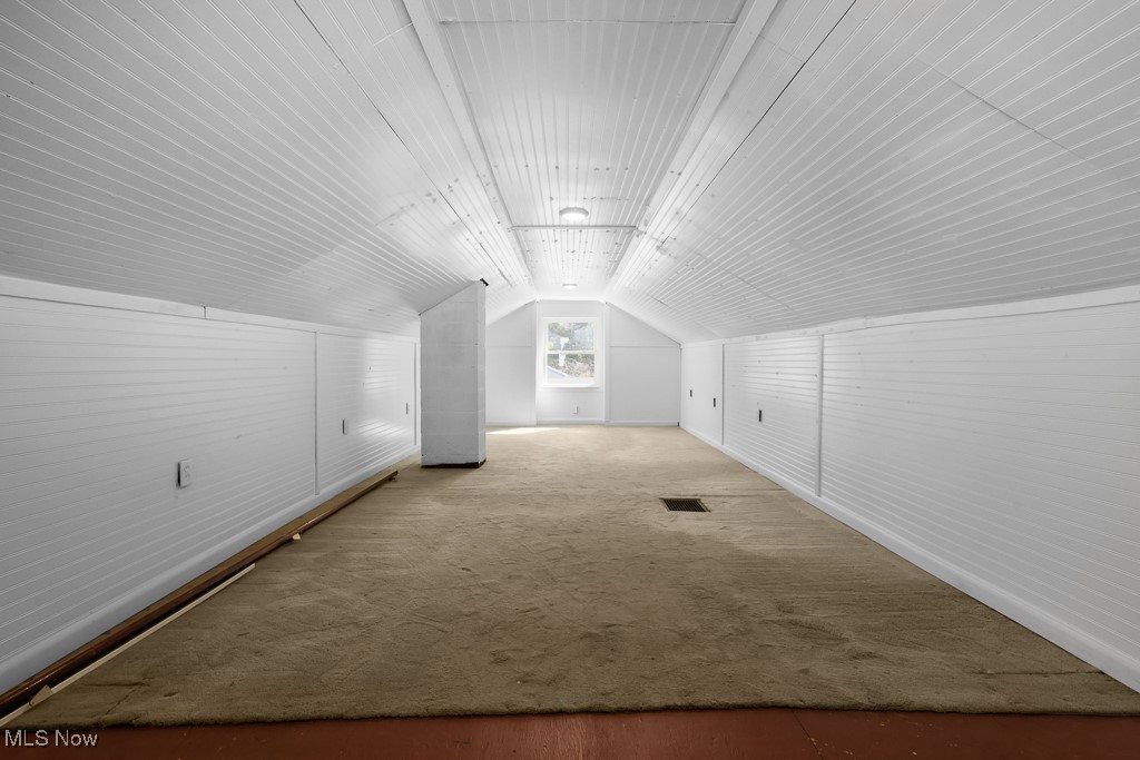 1702 Far View Road Akron, OH 44312 - Photo 25 of 49 Bonus room featuring lofted ceiling, carpet flooring, and wood finished floors