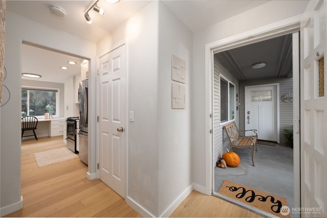 a hallway with dining area and glass door