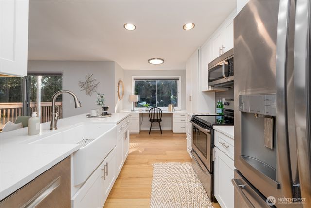 a kitchen with stainless steel appliances granite countertop a sink and cabinets
