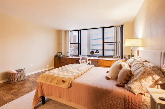 a bedroom with a bed and a large window