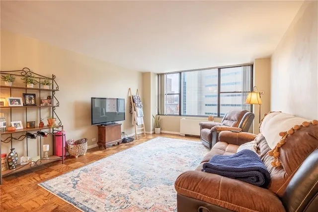 a living room with furniture and a flat screen tv