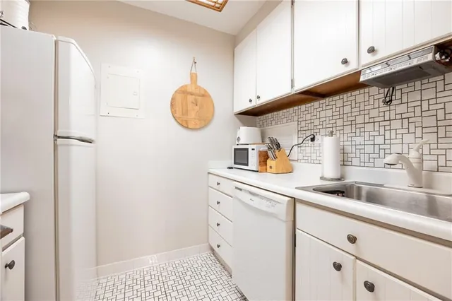a kitchen with a sink and cabinets