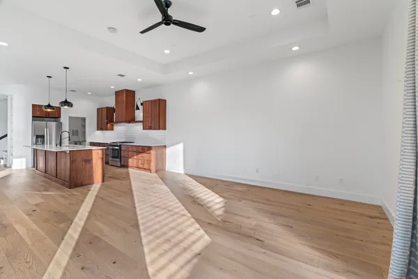 a view of walk in closet with wooden floor and furniture