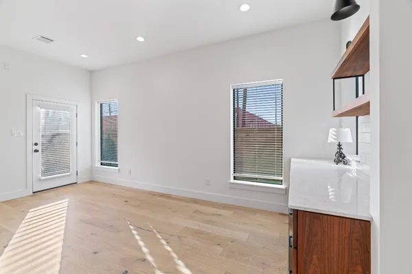 a living room with furniture and paintings on the wall