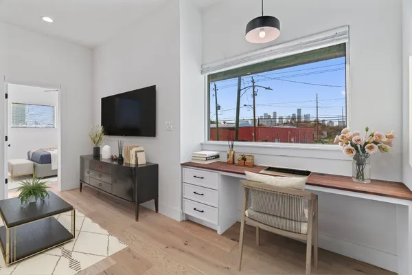 a bedroom with a large bed and a flat screen tv