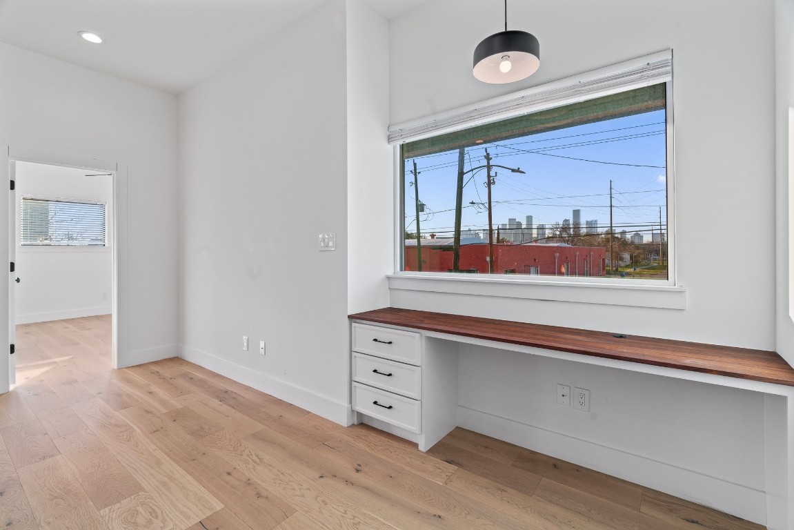 3802 Commerce Street Houston, TX 77003 - Photo 21 of 45 Dedicated workspace bathed in natural light, offering an inspiring setting for productivity with sweeping views of downtown Houston as your backdrop.