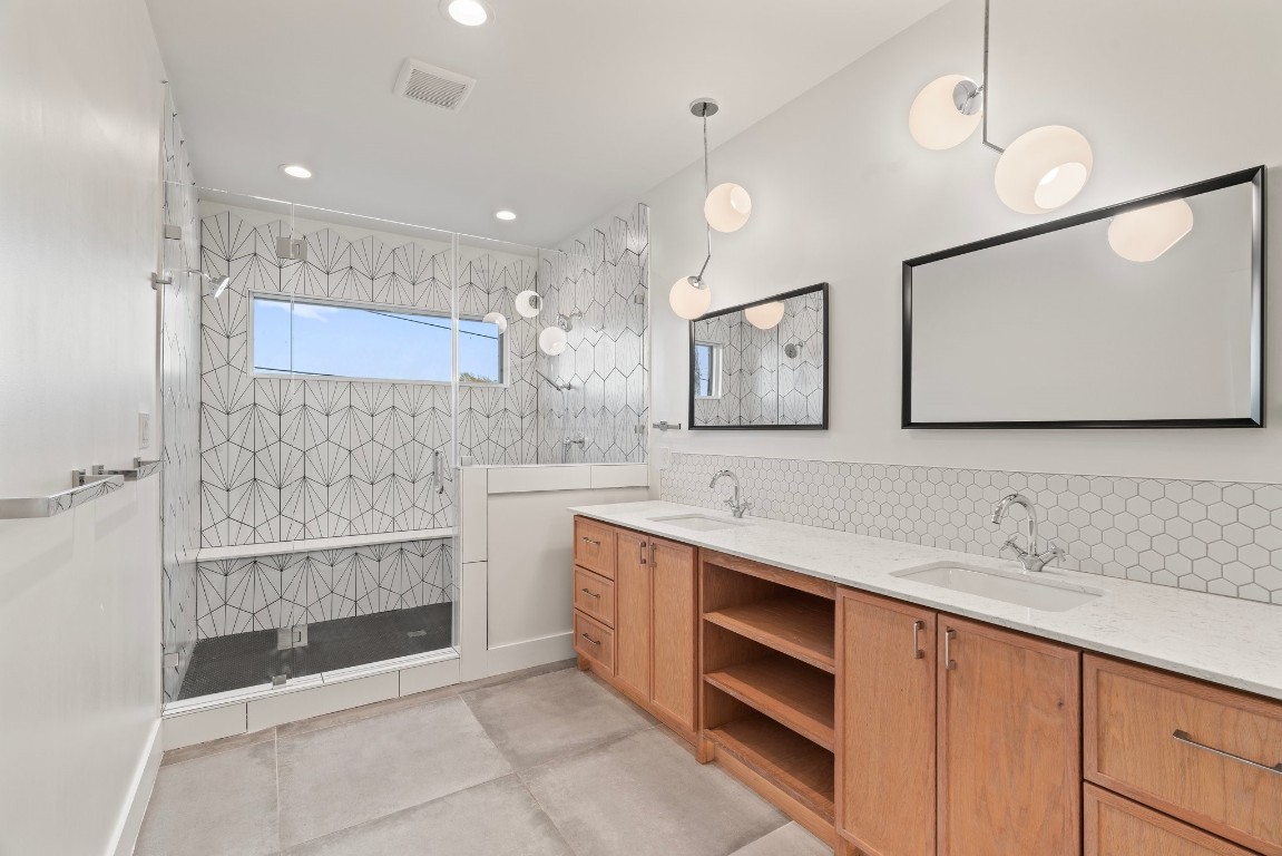 3802 Commerce Street Houston, TX 77003 - Photo 26 of 45 Modern primary bathroom with eye-catching tilework, dual sinks, sleek lighting, and plenty of storage. Designed to make busy mornings feel effortless.
