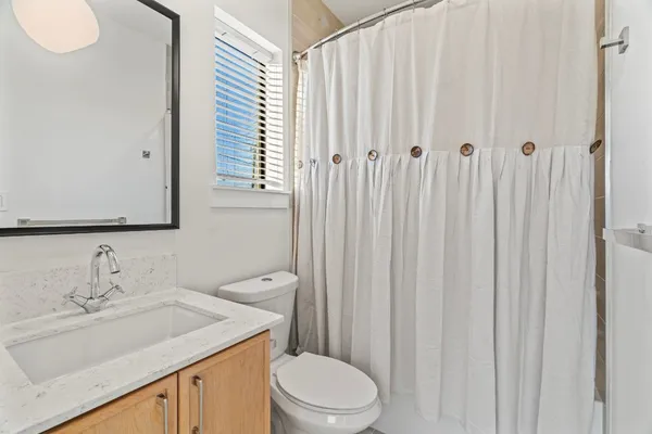 a view of a livingroom with a ceiling fan and window