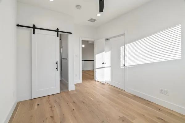 a bathroom with a granite countertop sink a toilet and shower