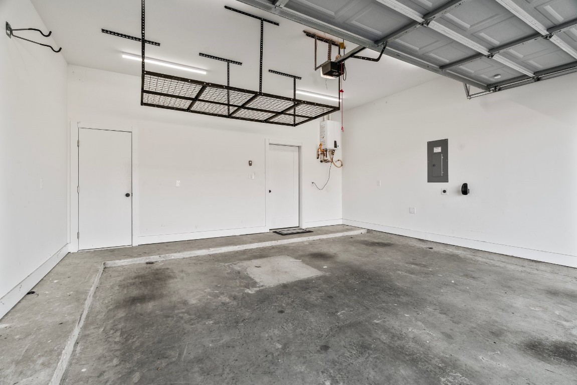 3802 Commerce Street Houston, TX 77003 - Photo 45 of 45 Garage with EV charging station, overhead storage, and additional closet storage.
