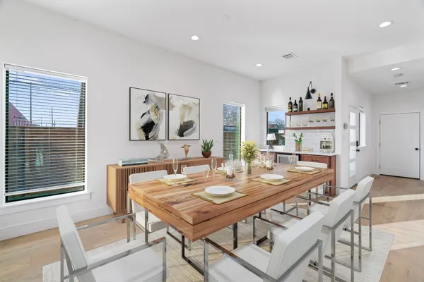 a view of a dining room with furniture and wooden floor