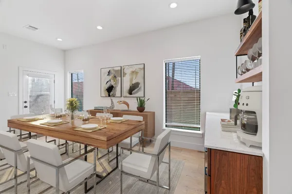 a view of a dining room with furniture and wooden floor