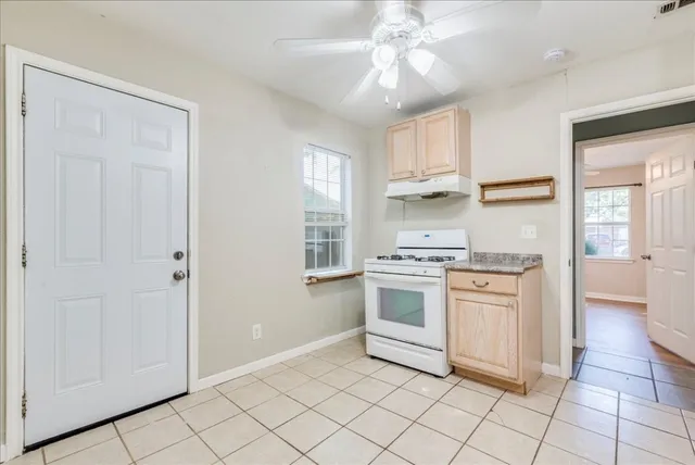 a kitchen with granite countertop white cabinets and white appliances