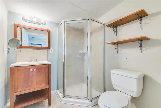 a bathroom with a toilet and a shower