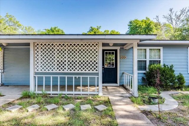 a view of a house with a balcony and yard