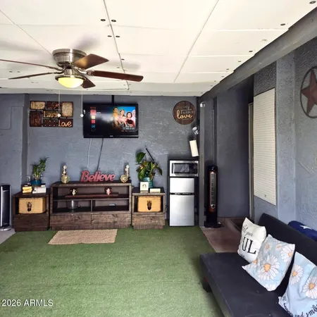a living room with furniture and flat screen tv