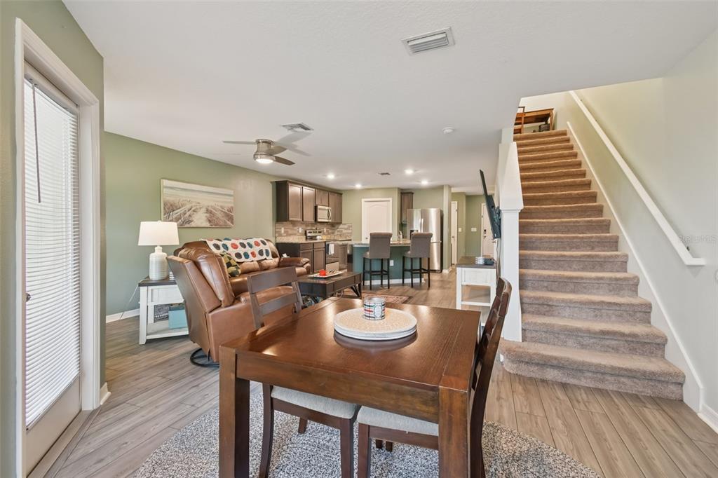 5228 New Friendship Place Tampa, FL 33619 - Photo 13 of 49 a view of a dining room and livingroom with furniture wooden floor a rug and a chandelier