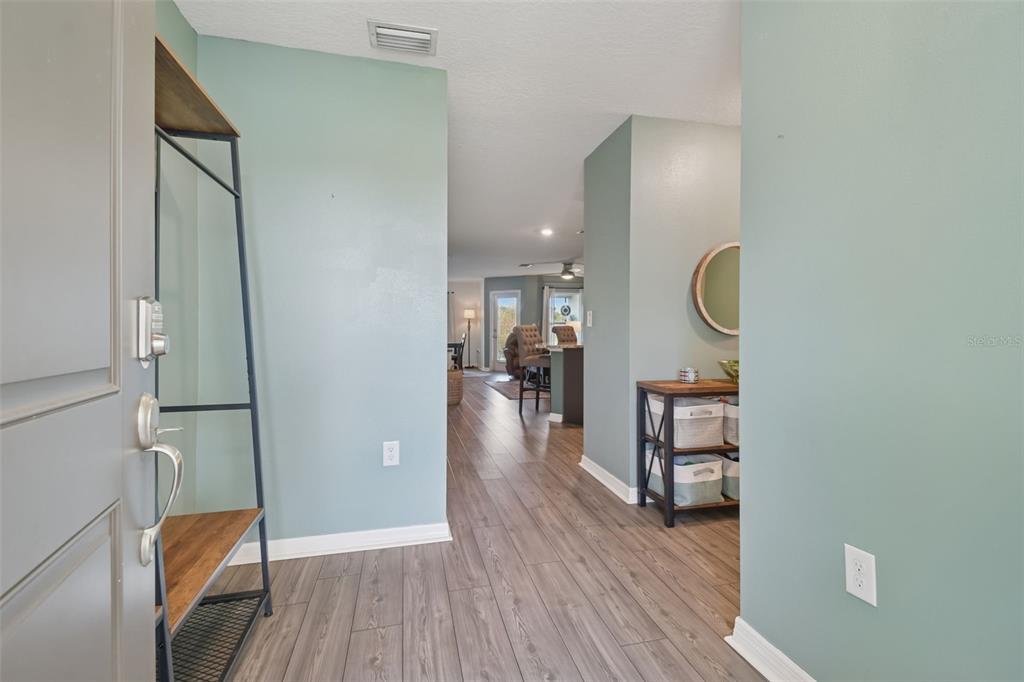 5228 New Friendship Place Tampa, FL 33619 - Photo 2 of 49 a view of a hallway view with wooden floor and staircase