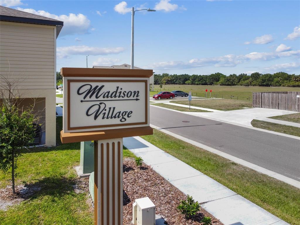 5228 New Friendship Place Tampa, FL 33619 - Photo 31 of 49 a street sign on a wall next to a yard