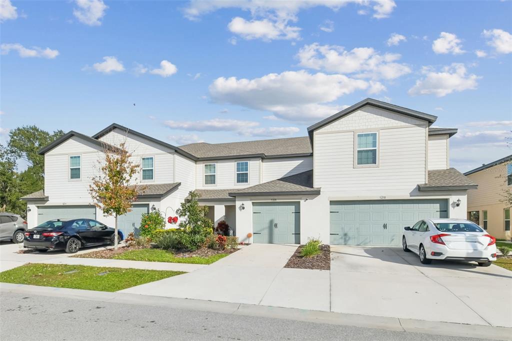 5228 New Friendship Place Tampa, FL 33619 - Photo 34 of 49 a front view of a house with a yard and garage