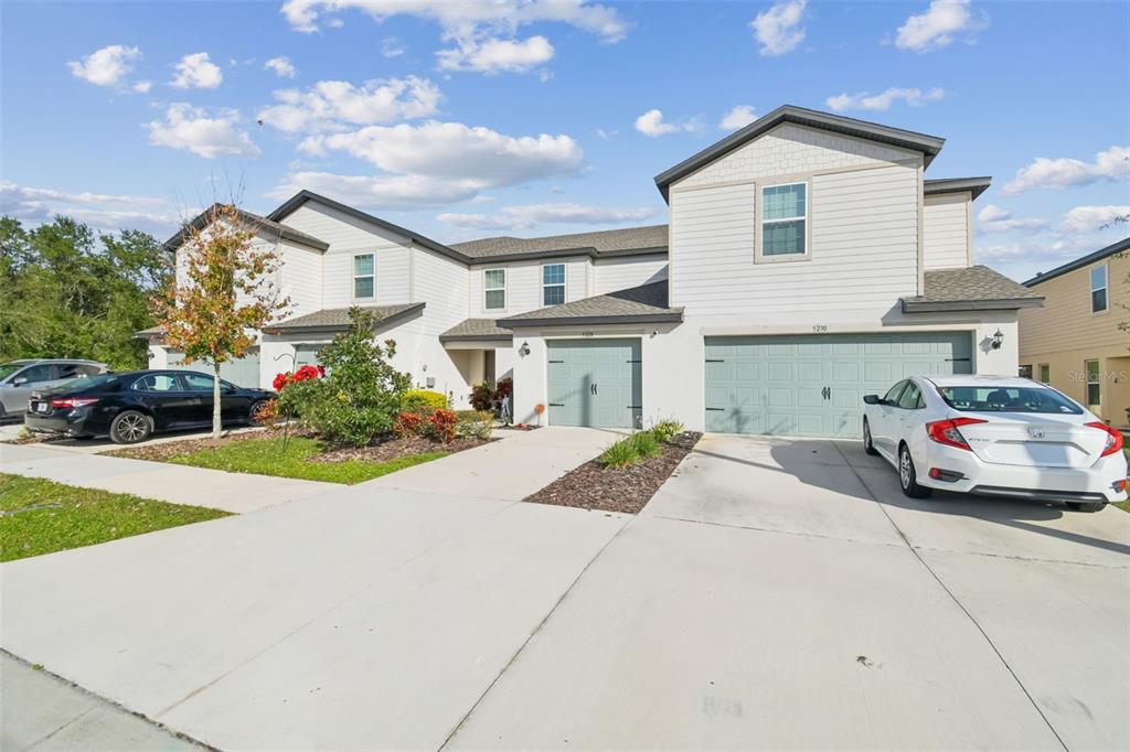 5228 New Friendship Place Tampa, FL 33619 - Photo 42 of 49 a front view of a house with a yard and a garage