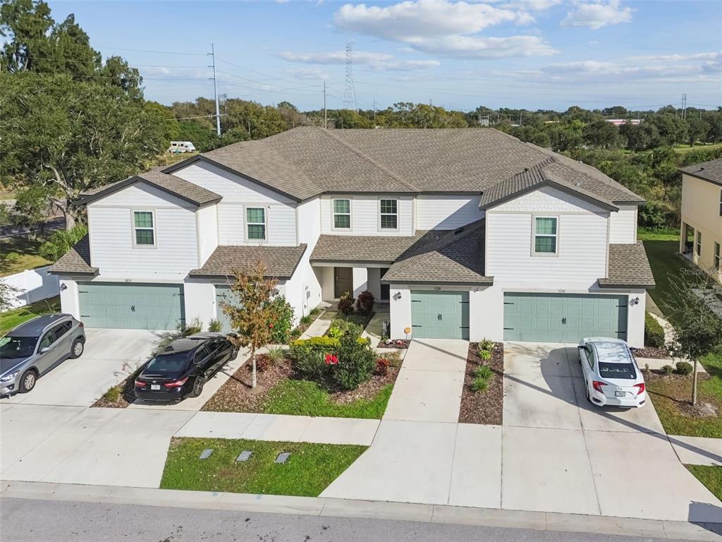 5228 New Friendship Place Tampa, FL 33619 - Photo 44 of 49 a view of a white house with a yard and balcony