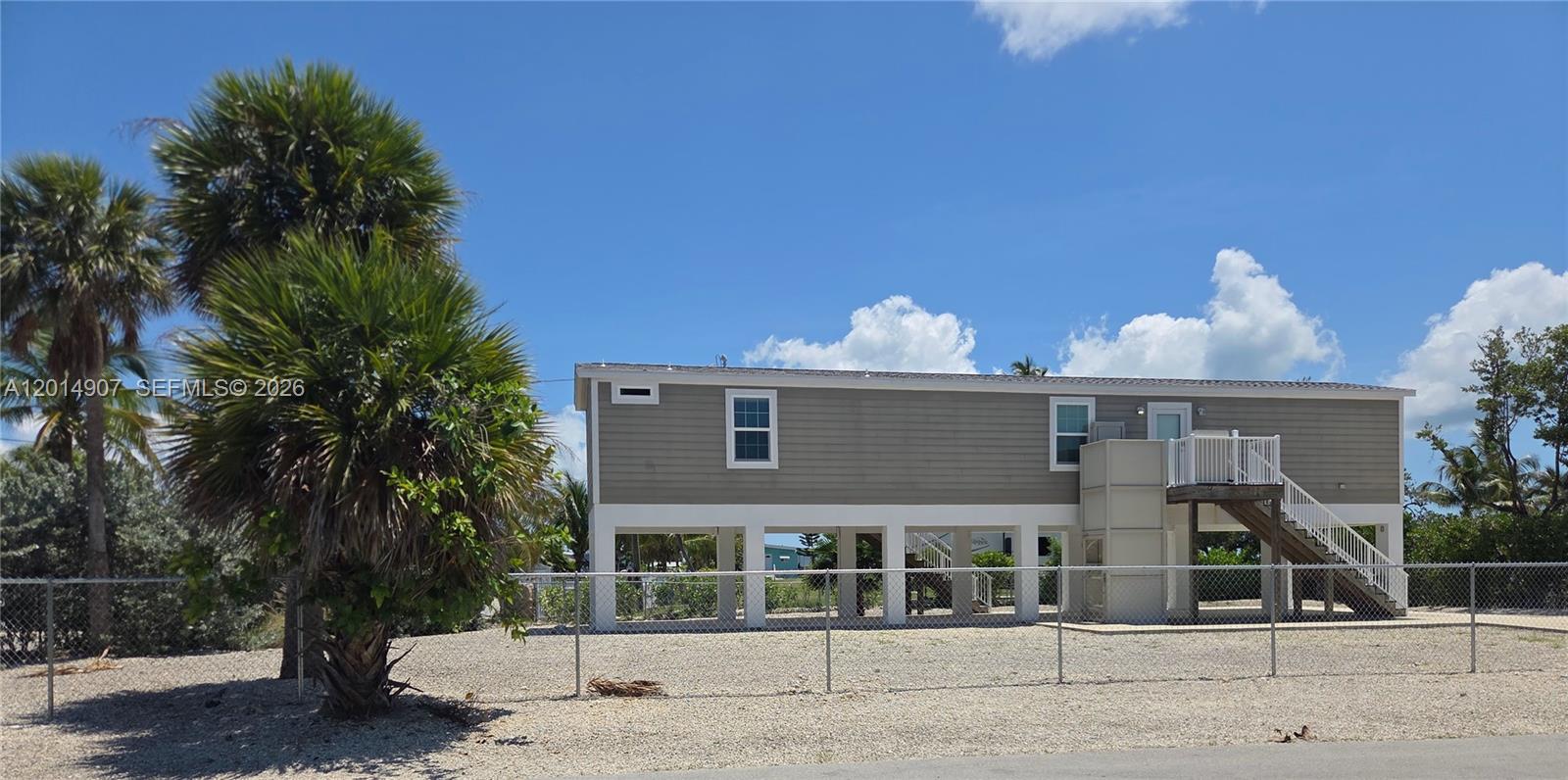 799 Hazel Street, Unit 799 Key Largo, FL 33037 - Photo 1 of 13 a front view of a house with a tree