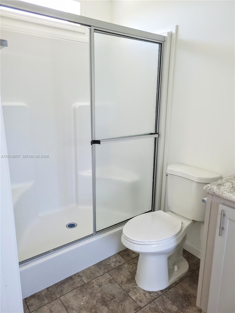 799 Hazel Street, Unit 799 Key Largo, FL 33037 - Photo 8 of 13 a white toilet sitting next to a shower
