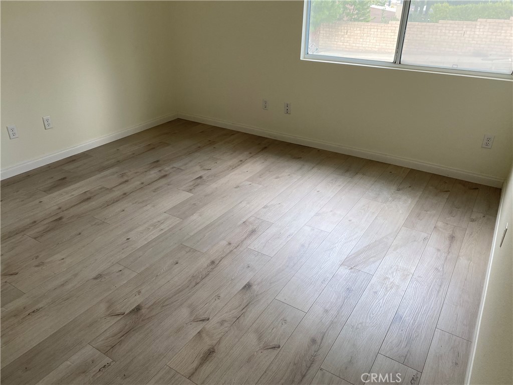 12671 Daryl Avenue Granada Hills, CA 91344 - Photo 7 of 10 an empty room with wooden floor and windows